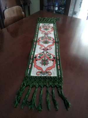 Handmade table runner with intricate crochet fringes and embroidery