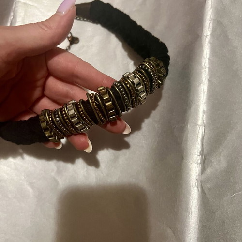 Iconic necklace with woven base and stone decoration