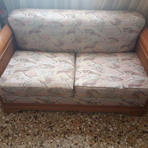 Two-seater sofa bed with wooden frame and rattan sides