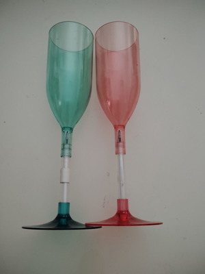 Plastic champagne glasses used, pink and green with hidden pen