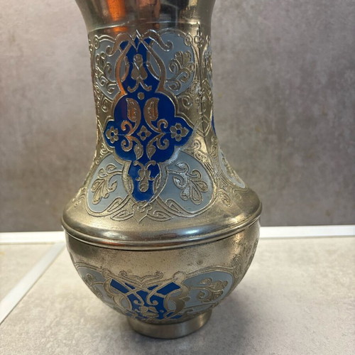 Vintage metal vase used with embossed designs and blue details