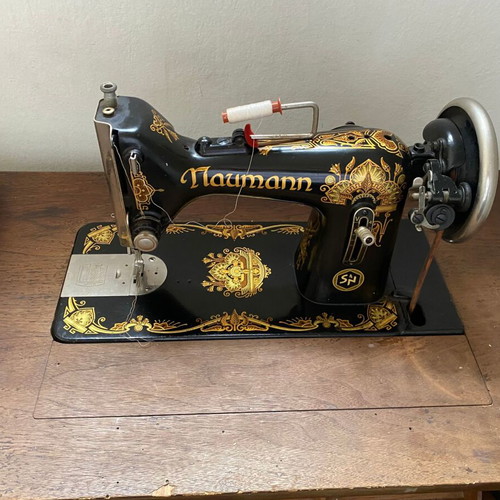 Naumann sewing machine used with cabinet and wheel