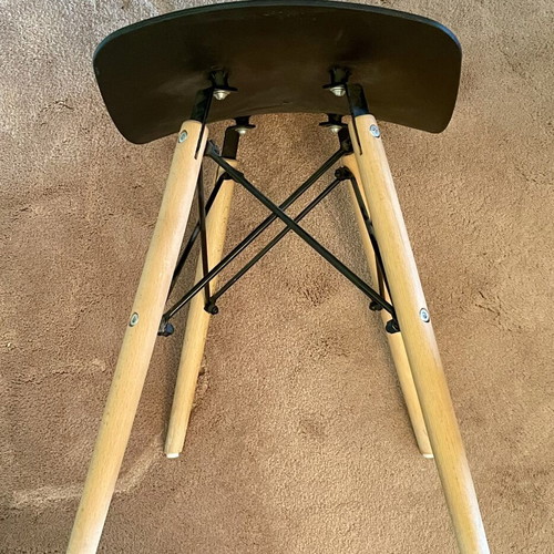 Low stool like new with black curved plastic seat and wooden legs