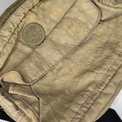 Kipling beige crossbody bag used with multiple compartments and strap
