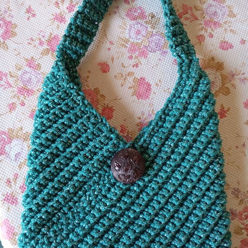 Handmade knitted handbag in turquoise green