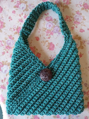 Handmade knitted handbag in turquoise green