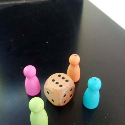 Wooden pawns with wooden dice used