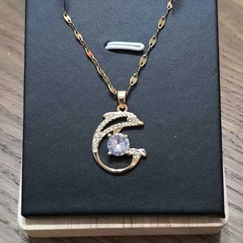 Necklace with dolphins and white stone, gold color