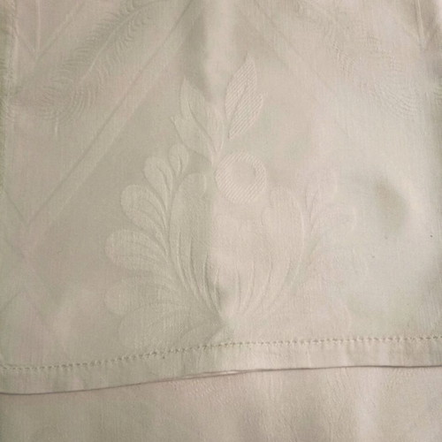 White tablecloth set with 12 used embossed napkins