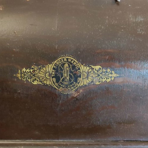 Singer sewing machine used with original wooden cover and key
