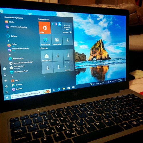 Quest Slimbook Plus 14.1" FHD laptop used with mouse and bag