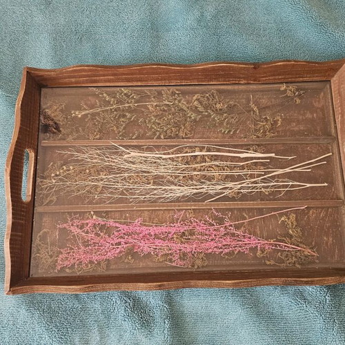 Wooden decorative serving tray used with dried flowers and glass surface