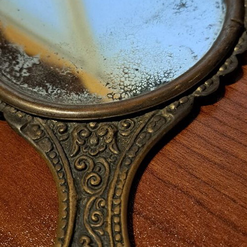 Brass hand mirror used with embossed peacock decoration