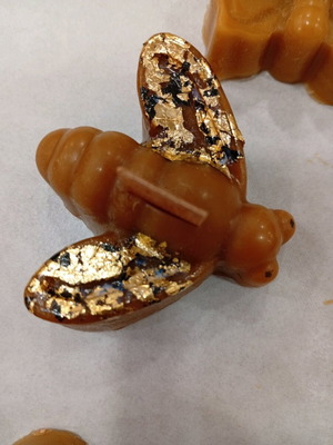 Bee candle handmade from pure beeswax with decorative gold leaf accents
