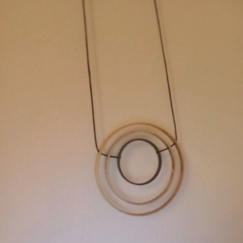Adjustable necklace used with gold, silver, and dark gray