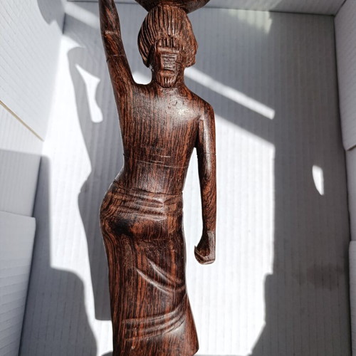 Rosewood figure of woman with basket from Bali, like new