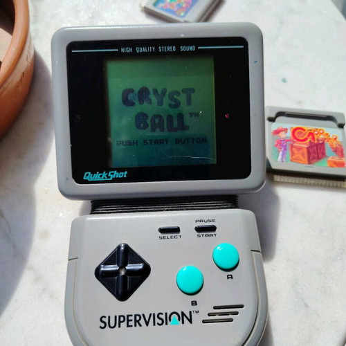 Watara Supervision console used with 3 games