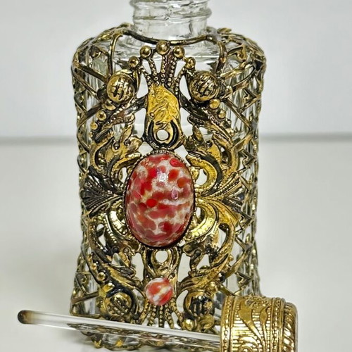 Vintage perfume flacon with filigree metalwork and red cabochon