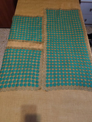 Table runner with two crocheted napkins and gold thread