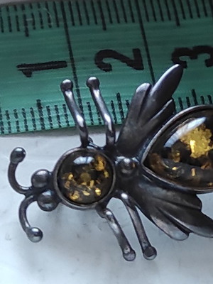 Silver brooch with amber used