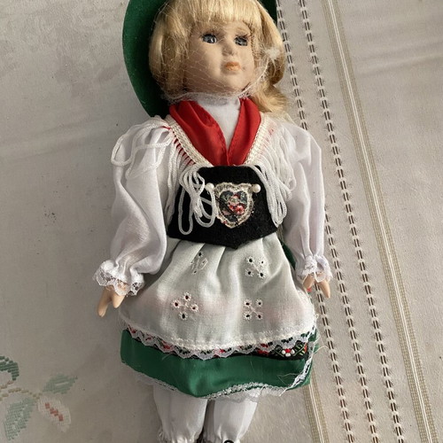Porcelain doll with traditional costume green and red like new