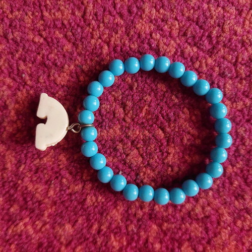 Children's turquoise bracelet with rainbow charm like new