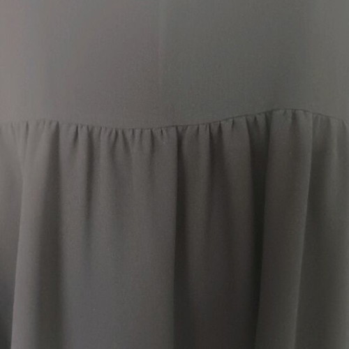 Sleeveless women's blouse black like new with ruffles and sheer detail