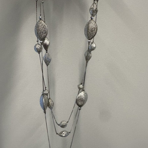 Triple necklace with silver pebble-like elements