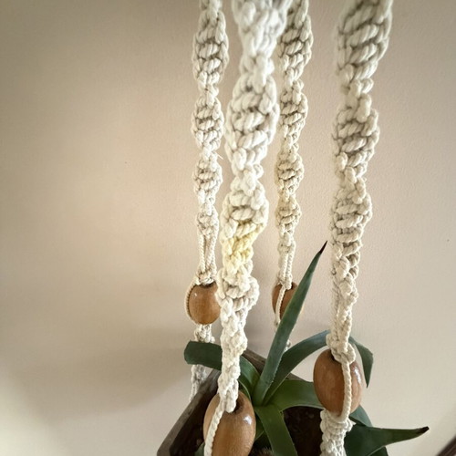 Macrame plant hanger used with wooden beads for pots
