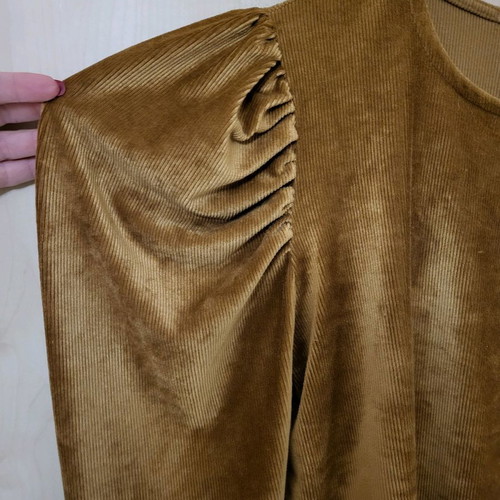 Gold blouse medium used with distinctive shoulders