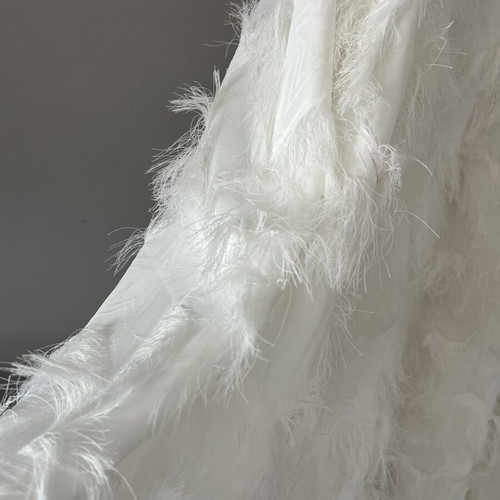White maxi skirt with feathers and silver waistband