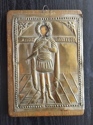 Antique embossed icon of Saint Fanourios used, metal on wooden base