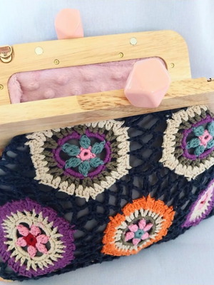 Handmade shoulder bag with knitted floral fabric and wooden clasp