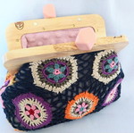Handmade shoulder bag with knitted floral fabric and wooden clasp