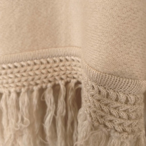 Knitted women's cape 100% wool, beige with fringes