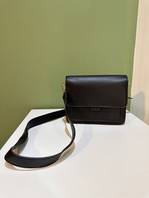 Black women's crossbody shoulder bag with gold details