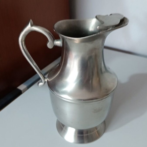 Vintage metal pitcher used with hinged lid and embossed handle