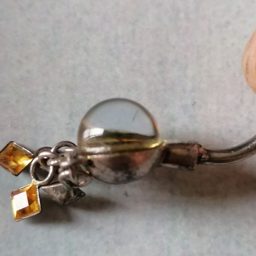 Aurora borealis navel piercing with color-changing crystal