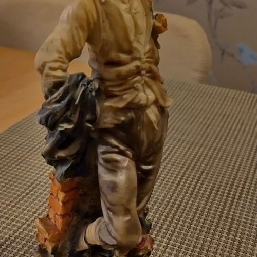 Decorative vintage figurine on wooden base like new