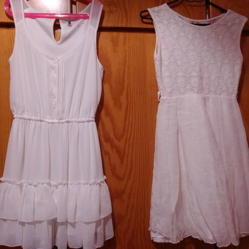 Two white dresses used, sizes 12-14 for girls