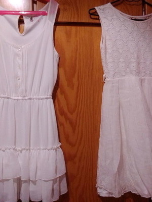 Two white dresses used, sizes 12-14 for girls