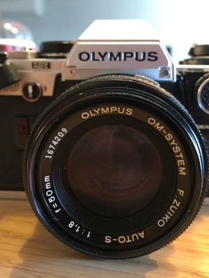 Olympus vintage camera used with lens and flash