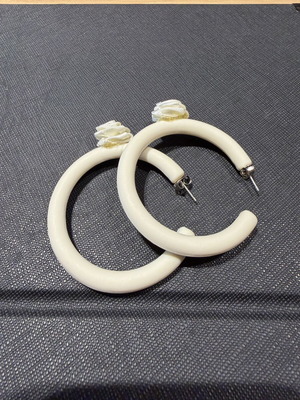 Pair of off-white matte resin hoop earrings with fabric floral accents