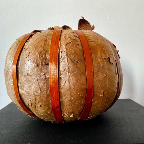 Decorative pumpkin wrapped with dried leaves like new