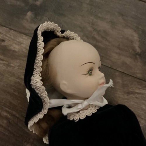 Porcelain doll with velvet dress and wooden chair like new