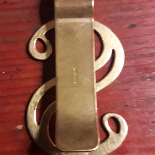 Gold-plated money clip used with $ symbol