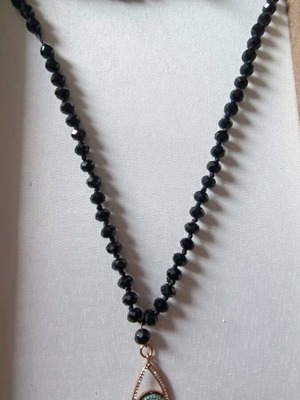 Long necklace like new with black stones and evil eye