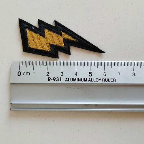Sewn patch in gold lightning bolt shape like new