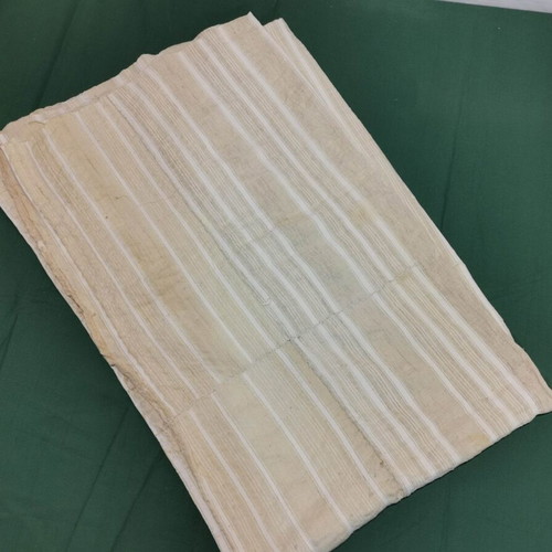 Woven bed sheet used with stain and wear from 1930 era