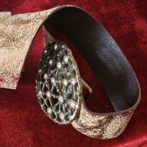 Wide gold belt used with decorative buckle and rhinestones